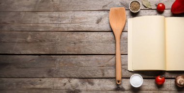 Boş kitapla kompozisyon, ahşap spatula ve ahşap arkaplanda metinler için boşluk olan malzemeler