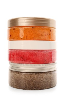 Jars with natural body scrub on white background