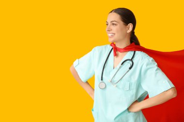 Sarı arka planda süper kahraman kostümlü güzel bayan doktor.