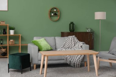 Şık oturma odasının içinde kanepe, masa ve puf