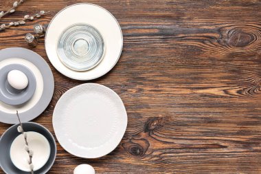 Paskalya yumurtaları ve ahşap arka planda söğüt dalları olan masa ayarı