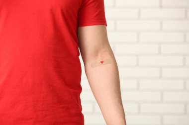 Blood donor with applied medical patch in clinic