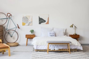 Yatak odasının içi. Büyük yataklı, komodinli ve bisikletli.