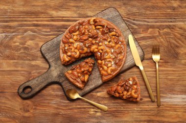 Farklı fındıklı tatlı tart ve ahşap arka planda karamel.