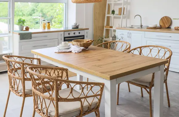 Mutfakta hasır sandalyeli yemek masası.