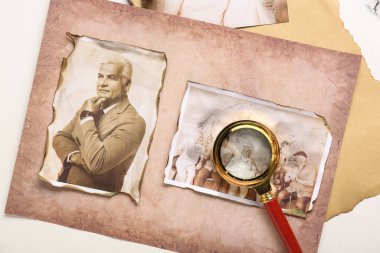 Beyaz arka planda büyüteçle akrabaların eski fotoğrafları. Aile ağacı kavramı