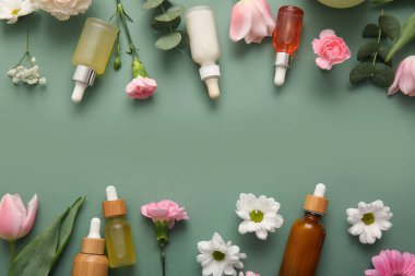 Farklı kozmetik ürünleri ve yeşil arka planda güzel çiçekler.
