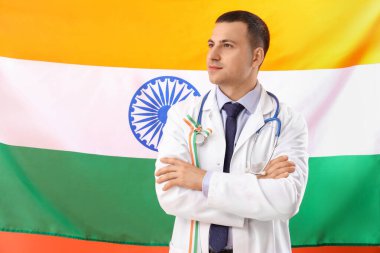 Hindistan bayrağına karşı kurdeleli bir erkek doktor. Ulusal Doktorların Günü kutlaması