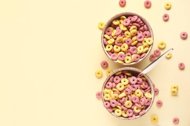 Bej arkaplanda mısır gevreği halkaları olan kaseler