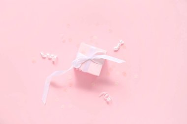 Renkli konfeti ve yılanbalığıyla pembe hediye kutusu.