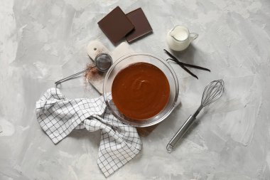 Gri arka planda lezzetli erimiş çikolatalı kase. Üst görünüm