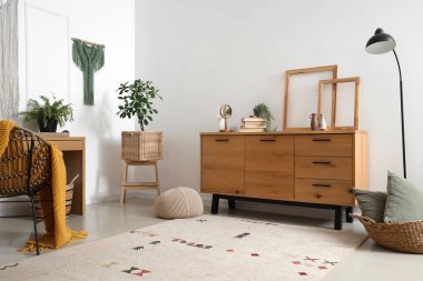 Interior of cozy office with workplace and wall tapestries