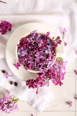 Üzerinde güzel leylak çiçekleri ve peçeteler olan kompozisyon.