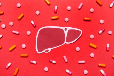 Kırmızı arka planda haplı kağıt karaciğer.