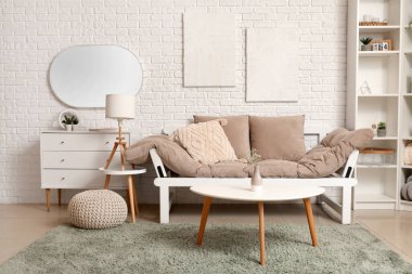 Oturma odasının içinde kanepe, sehpa ve ayna var.