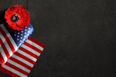 Flag of USA and poppy flower on dark background. Memorial Day celebration