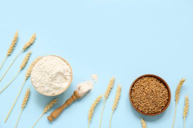 Mavi arka planda buğday unu, tahıl ve çivili kaseler