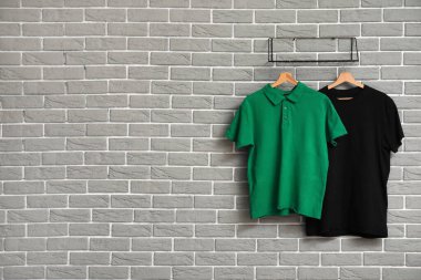 Gri duvarda asılı şık tişörtler
