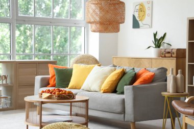 Oturma odasının iç tarafındaki kahve masasında rahat bir kanepe ve kayısı tepsisi.