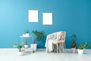 Hasır koltuklu, masalı ve mavi duvarlı farklı evlerden oluşan bulanık bir oturma odası.