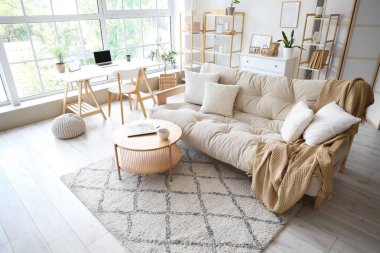 Kanepesi ve masası olan modern aydınlık oturma odasının içinde.