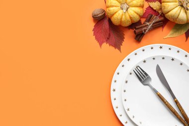 Taze kabaklar, ceviz, tarçın ve turuncu arka planda sonbahar yapraklarıyla güzel bir masa.