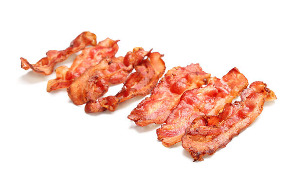 Many fried bacon rashers on white background
