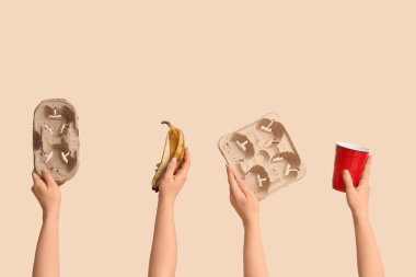 Bej arka planda çöp olan kadın elleri. Küresel Geri Dönüşüm Günü