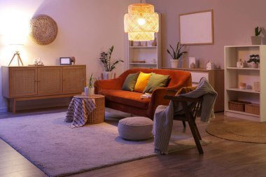 Akşamları koltuğu, koltuğu ve parlayan lambası olan oturma odasının içinde.