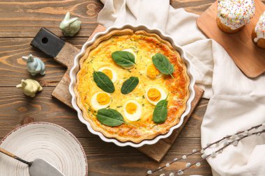 Delicious Easter egg tart with sweet cakes and pussy willow branches on wooden background