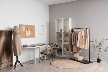 İş yeri, elbise askılığı ve mankeni olan bir stilistin stüdyosu.