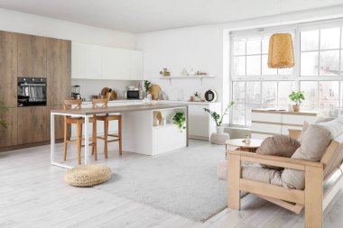 Kanepesi ve mutfak tezgahı olan modern stüdyo dairesi.