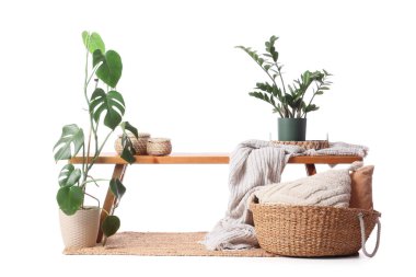 Tahta bank, sepetler ve beyaz arka planda bitkiler.