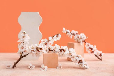 Güzel çiçek açan ağaç dallarıyla dekoratif podyumlar ve renkli arka planda çiçekler