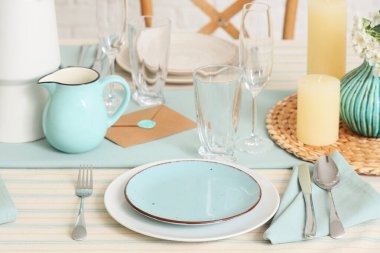 Tabakları, bardakları ve çiçek açan ağaç dalları olan zarif bir masa. Yakın plan.