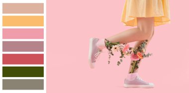 Woman with flowers in socks on pink background
