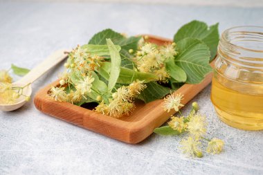 Taze ıhlamur çiçekli ahşap tahta ve arka planda bal