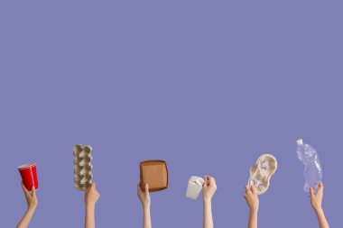 Leylak arka planında farklı çöpleri tutan kadın eller. Geri dönüşüm kavramı