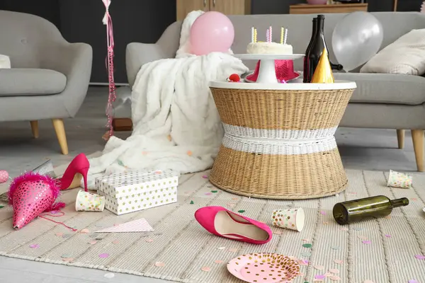 Doğum günü kutlamasından sonra dağınık oturma odasında parti dekorlu topuklar.