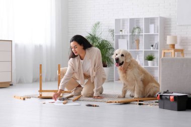 Evinde sevimli köpeğini toplayan genç Afro-Amerikalı kadın.