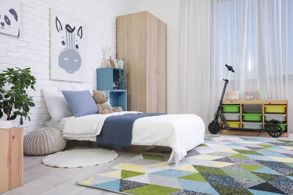 Yataklı, raflı ve scooterlı çocuk odasının içi.