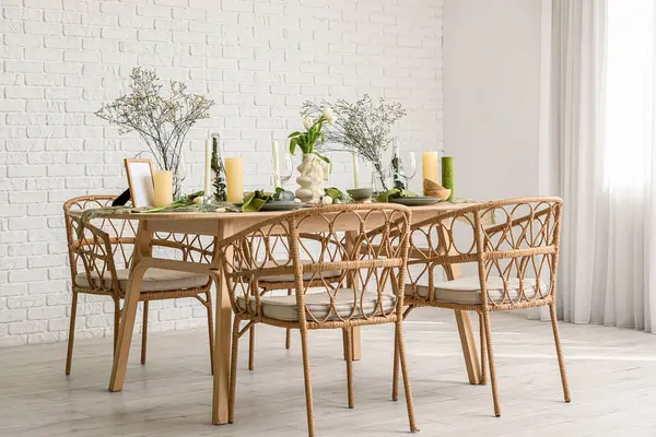 Hafif yemek odasında güzel çiçekler ve mumlar olan zarif bir masa.