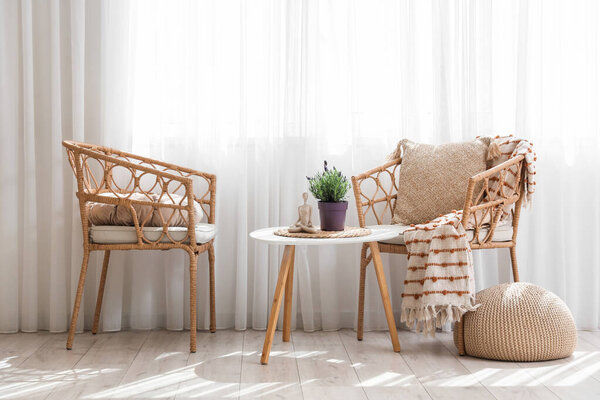 Interior of living room with armchairs and lavender flowers on table