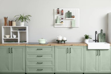 Tahta ve mutfak gereçleri olan şık bir mutfak.