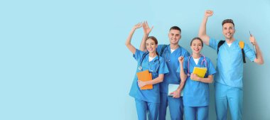 Açık mavi arkaplan ve metin için alanı olan mutlu tıp öğrencileri grubu