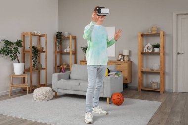 Evde VR gözlük kullanan bir erkek öğrenci.