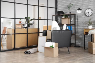 Taşındığı gün karton kutular, eşyalar ve koltuk olan modern ofis.