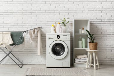 Çamaşır makinesi ve kurutuculu hafif çamaşır odasının içi.