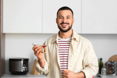 Mutfakta lezzetli Meksika taco 'su olan genç adam.