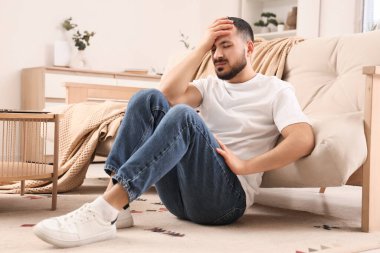 Genç adam kendini halının üstünde kötü hissediyor.